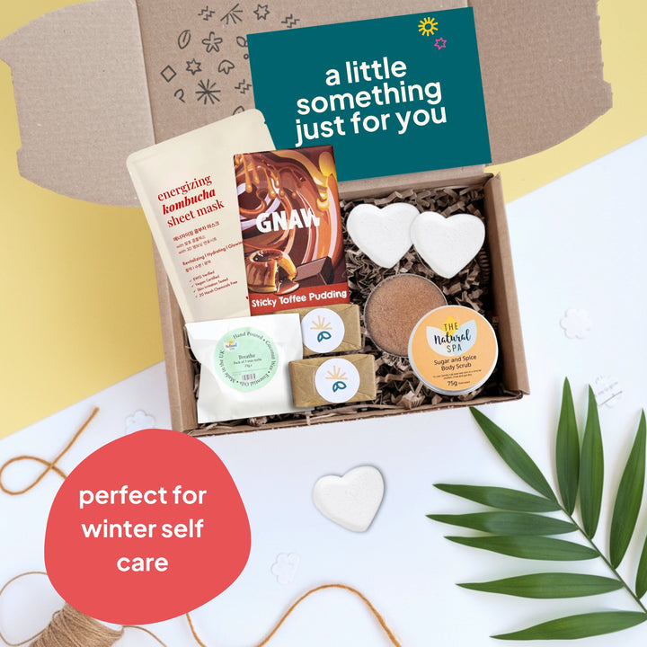 Gift box with self-care items on a white background