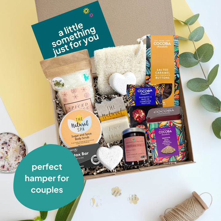 Gift hamper with various items including soap bars and candies, labeled 'perfect hamper for couples'.