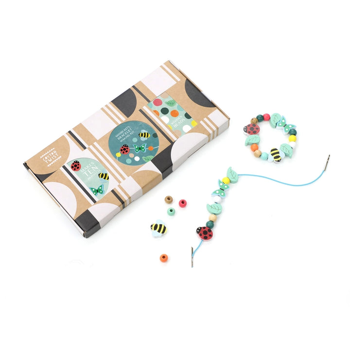 Colourful beaded bracelet kit with packaging on a white background