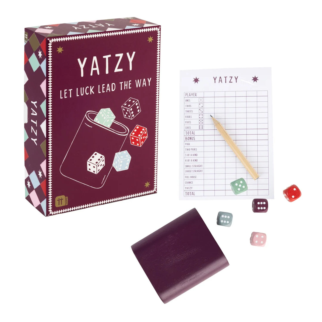Yatzy game set with packaging, dice, and score sheet on a white background