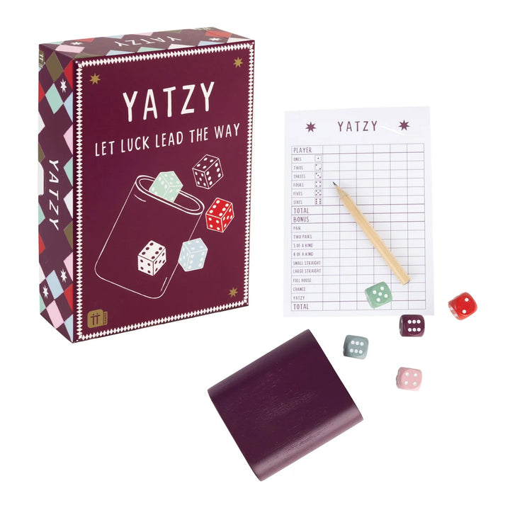 Yatzy game set with packaging, dice, and score sheet on a white background