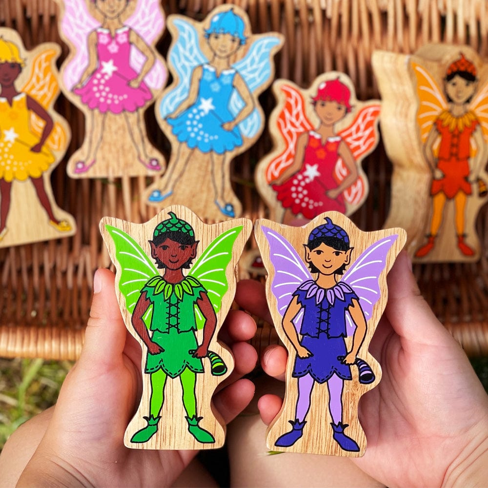 childs hands holding two fairies - one green and one purple - from the Lanka kade rainbow fairies playset 