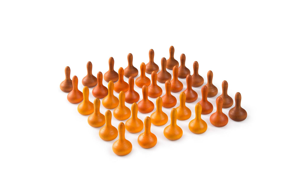 A collection of small, wooden Grapat Mandala Pumpkins in various shades of orange and brown, arranged on a white surface.