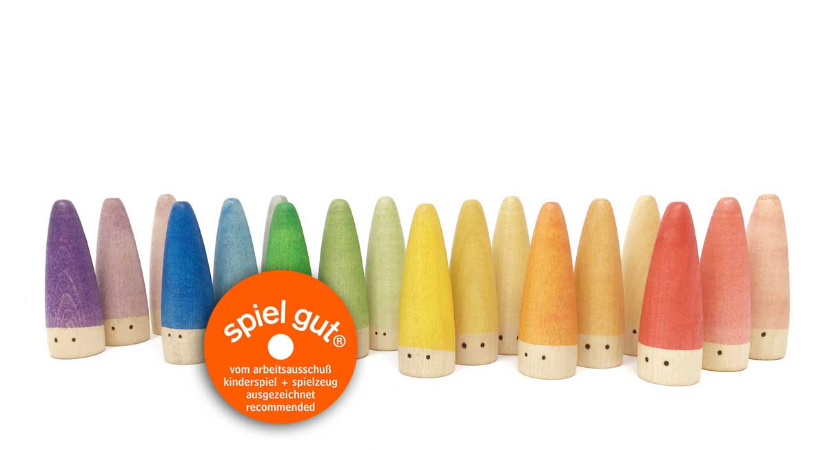 a line of Grapat Palos or Sticks painted in rainbow colours with little eyes 