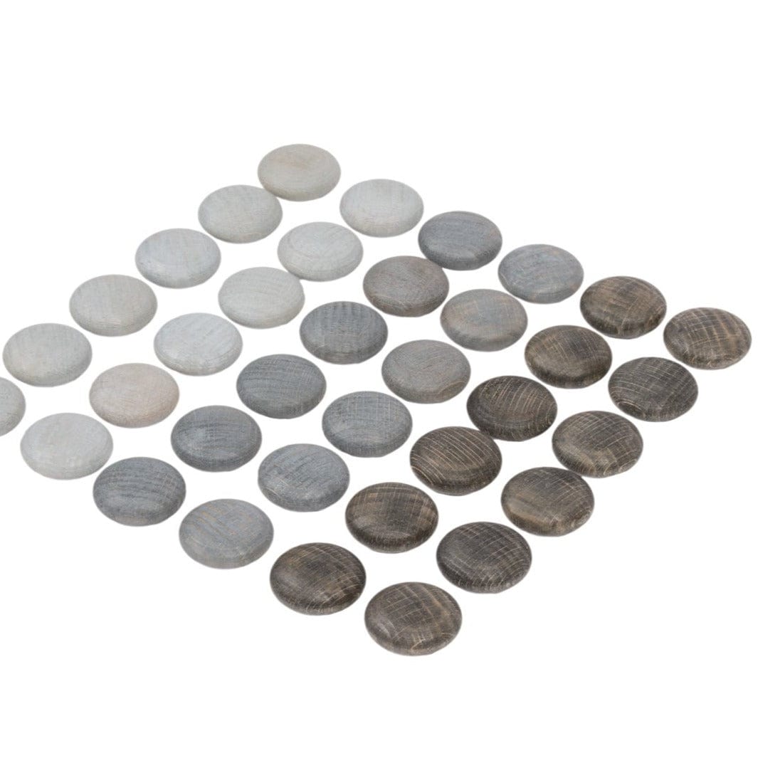 A collection of Grapat mini wooden stones in various shades of grey, arranged in an patterned formation on a white background.
