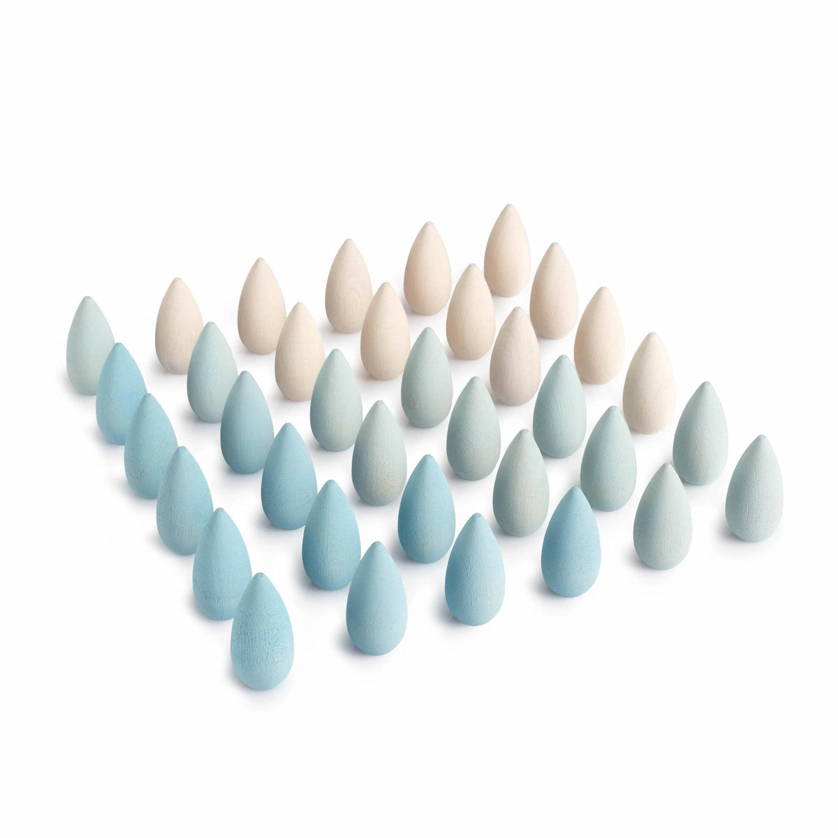 A collection of wooden snowflake shaped pieces in various shades of ice white and blue, arranged in rows.