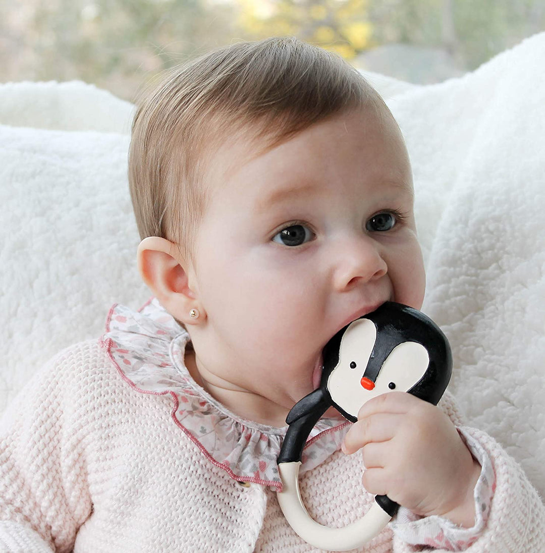 baby chewing a lanco rubber penguin teether
