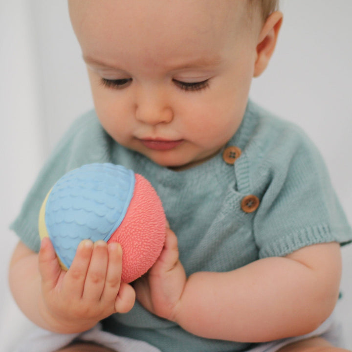 baby holding lanco pastel sensory ball