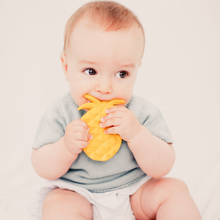 baby chewing a lanco pineapple teething toy 