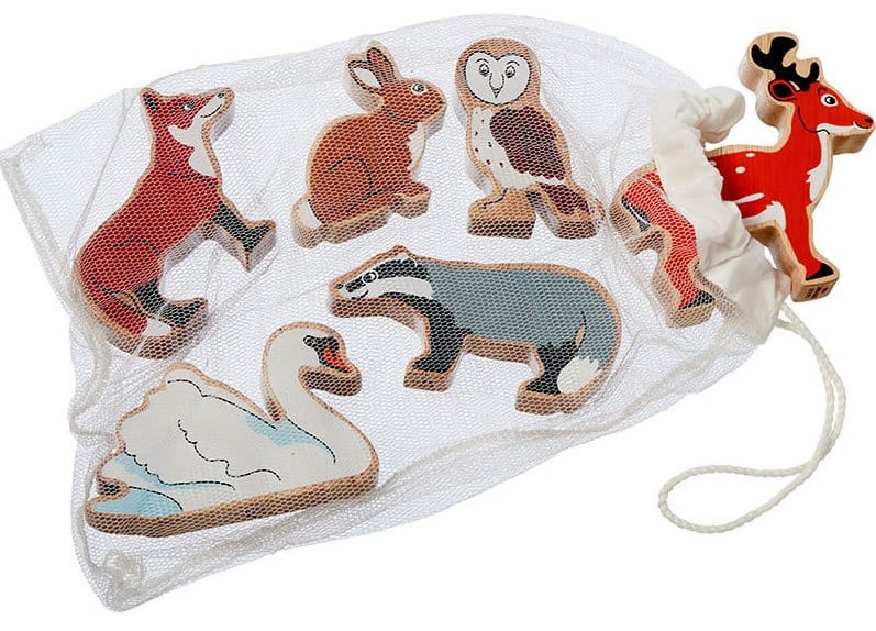 six wooden painted  countryside animals including owl, deer, fox, swan, badger and rabbit in a cotton bag