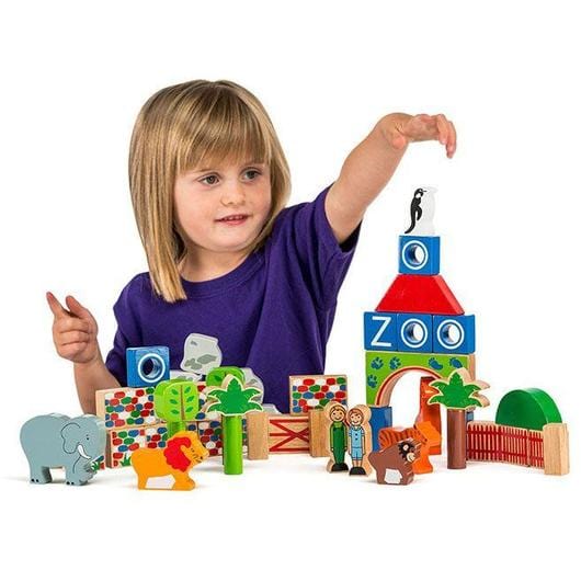 girl playing with lanka kade zoo building blocks including wooden animals, fences, blocks and people. For 10 months and over.