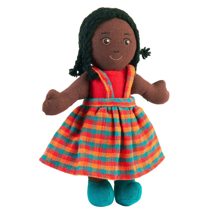 A handcrafted doll with black skin and black hair, wearing a colorful striped dress and blue shoes.