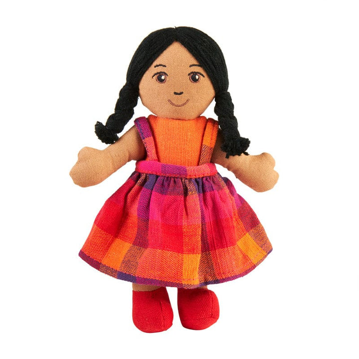 handmade cloth girl doll with brown skin and black hair. She is wearing a colourful orange and red dress with red shoes. 