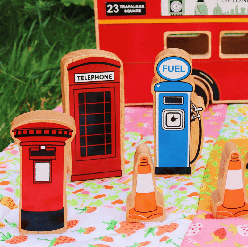 brightly coloured wooden telephone box, post box, fuel pump and traffic cones for small world play