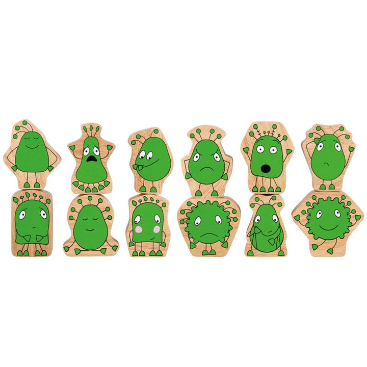 A set of wooden toy figures with green faces and different emotional expressions, including angry, sad, happy, and scared.