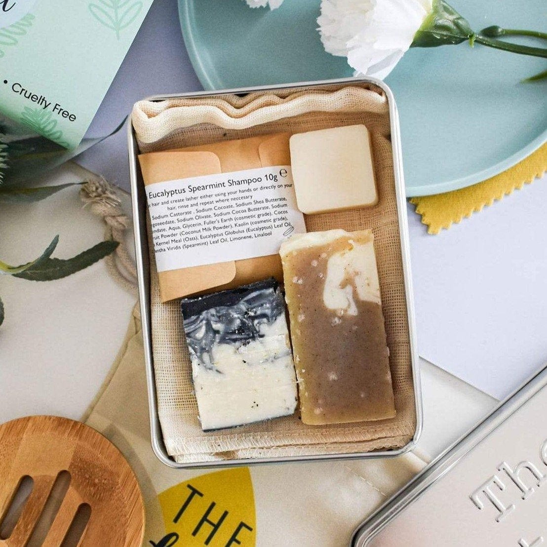mini on the go travel kit with travel size soaps, shampoo and conditioner in a tin