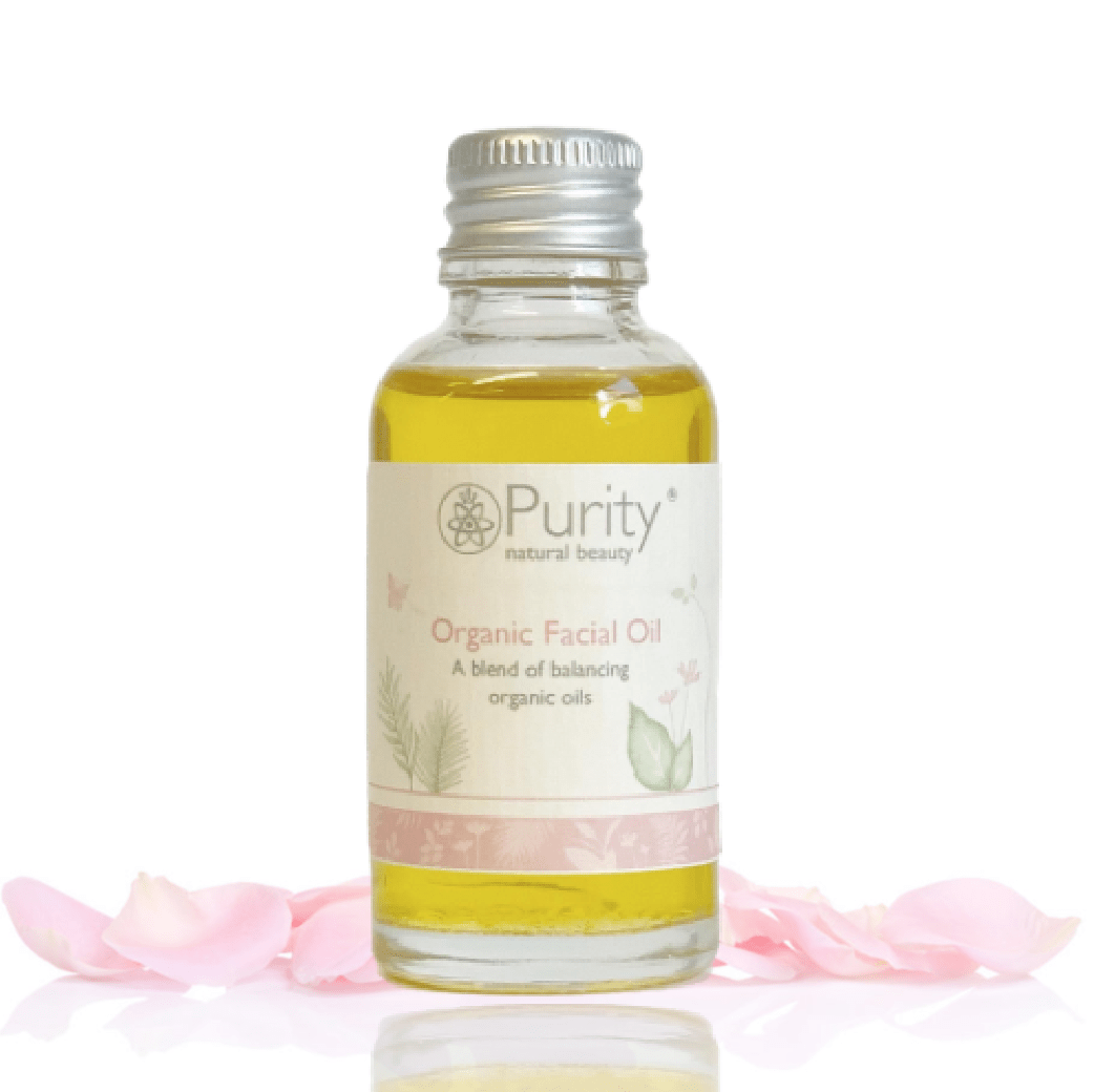 a glass bottle of orgnaoc facial oil by purity natural beauty