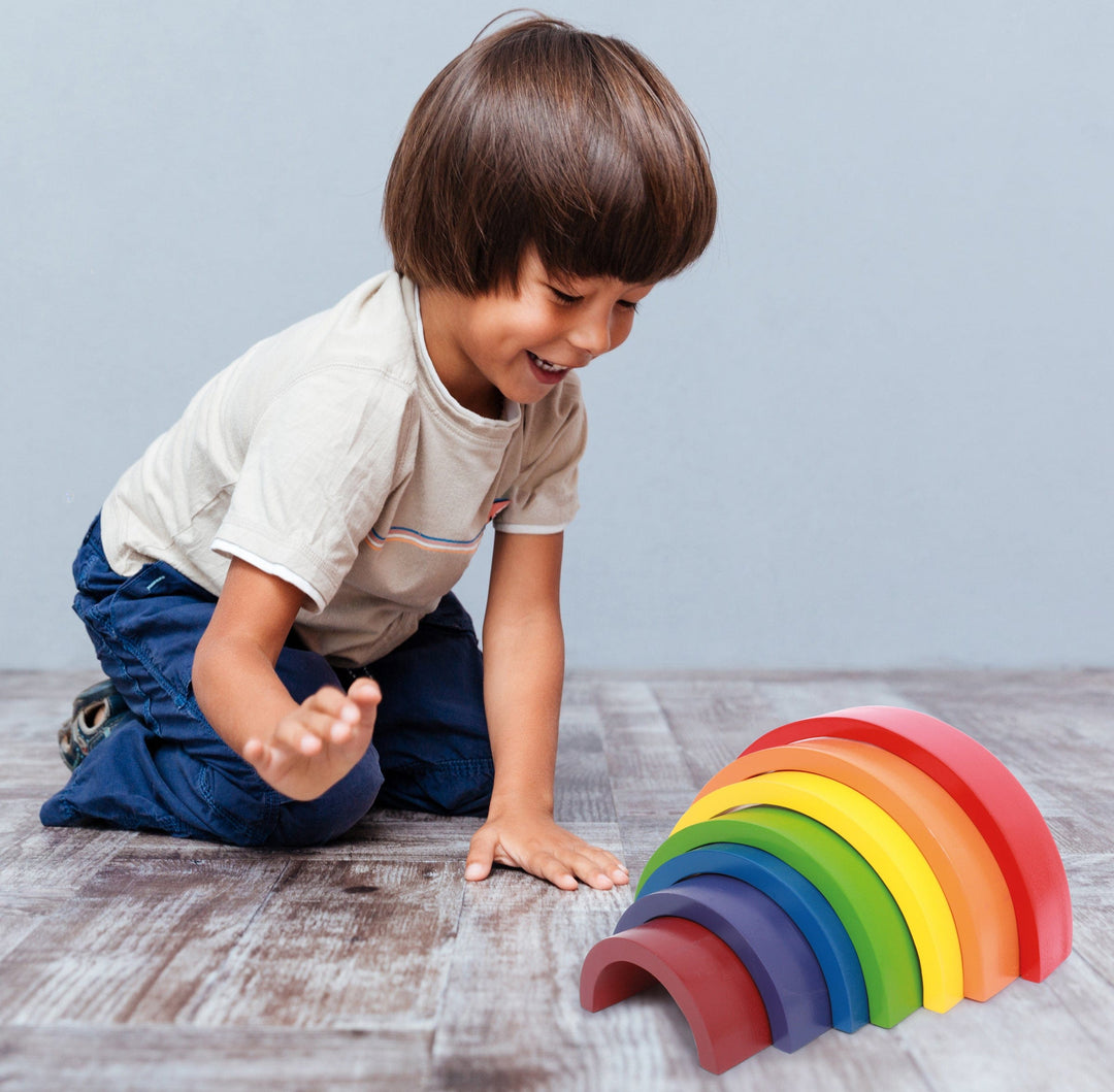 boy playing with Small Foot Rainbow Building Blocks 