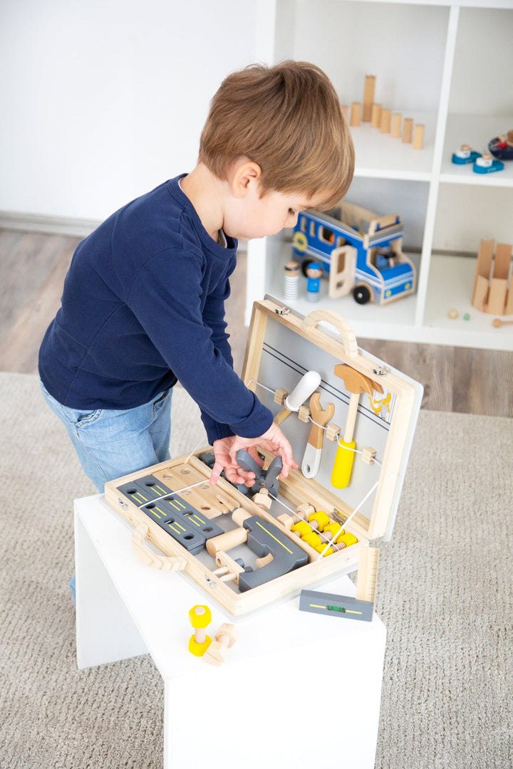 boy playing with Small Foot Wooden Toolbox
