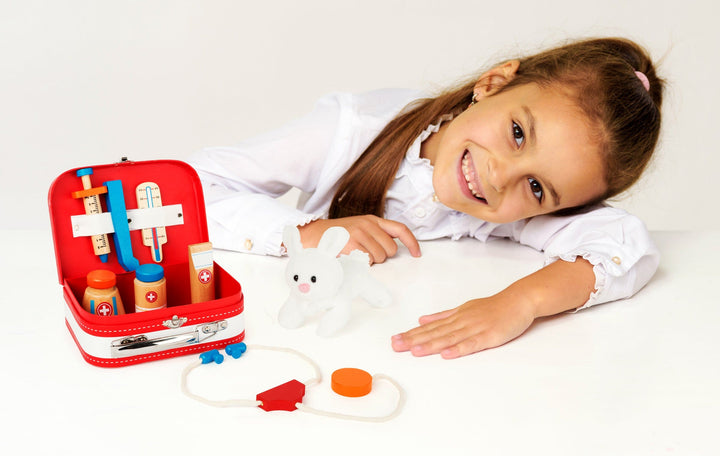 girl playing with Small Foot Vets Case Play Set