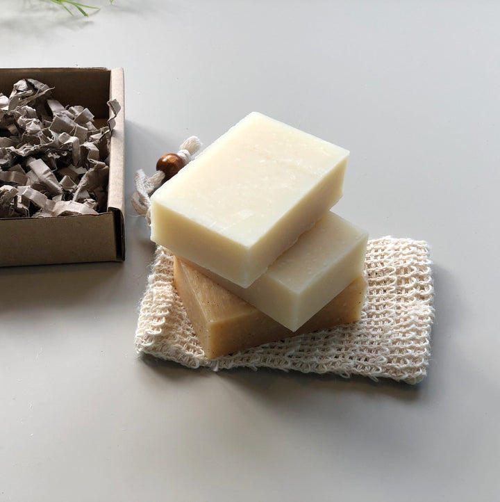 Three unpackaged soap bars for Face, Body and Hair with a sisal soap saver pouch